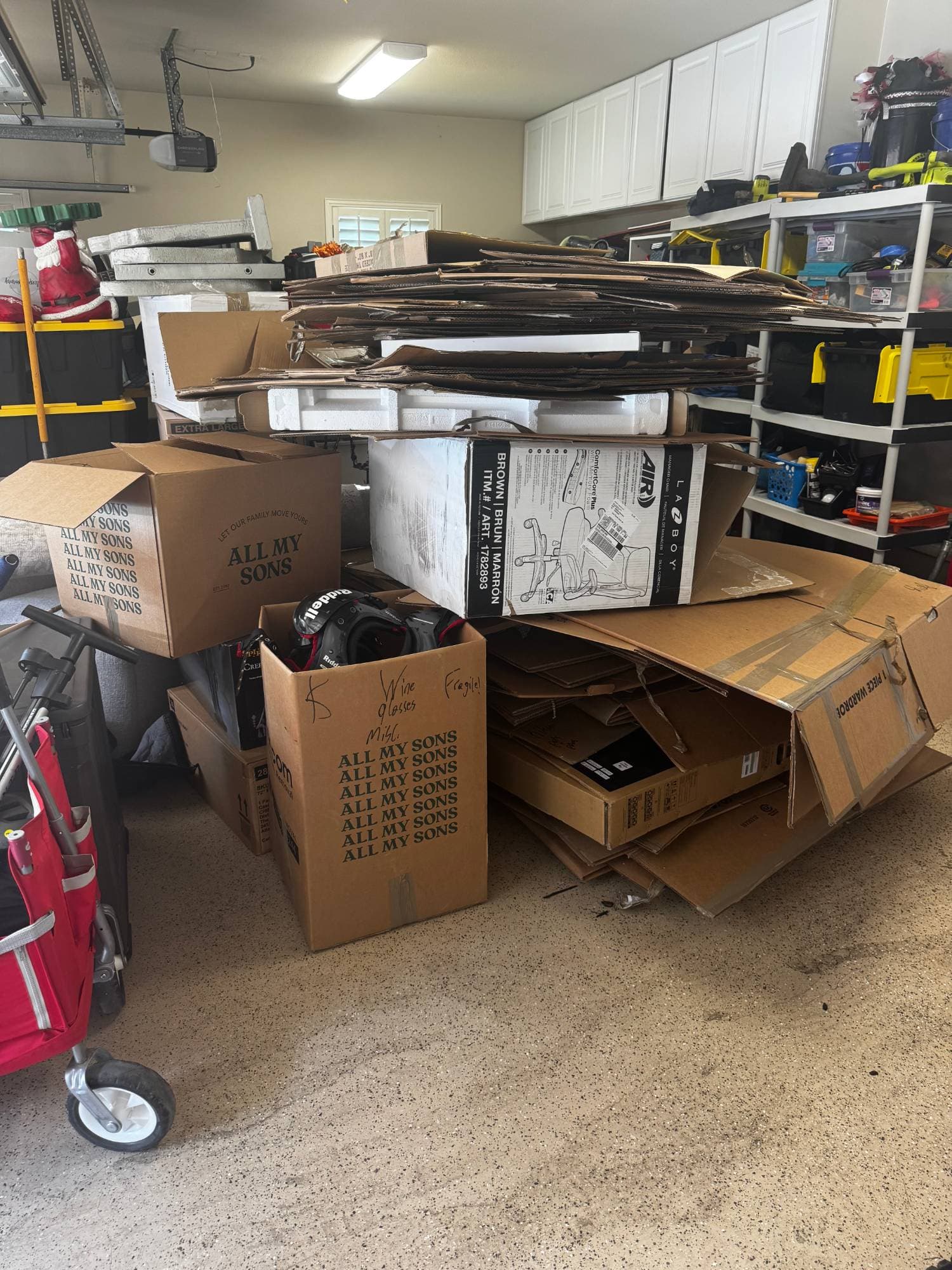 Garage packed with moving boxes and cardboard before HAULR cleanout